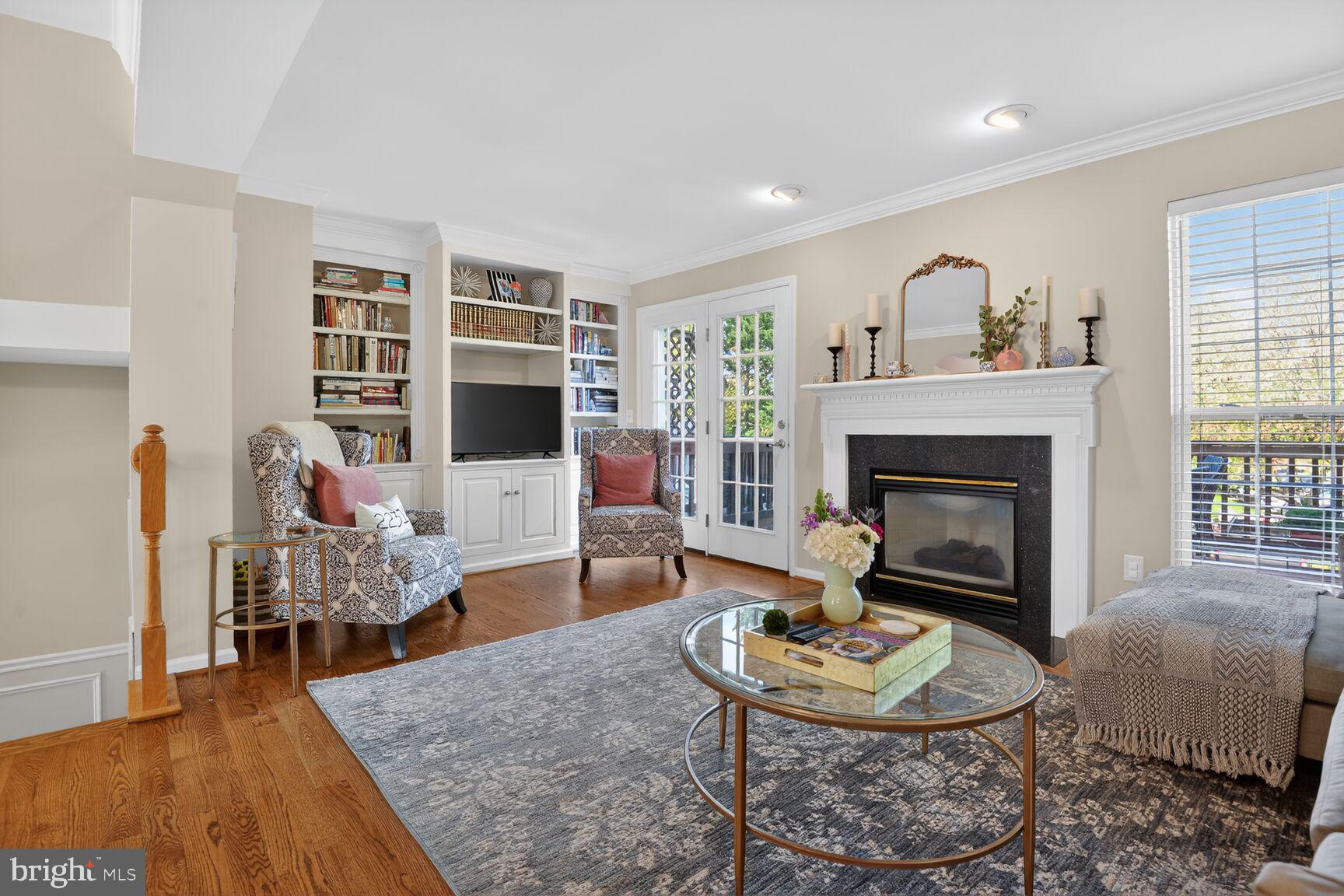 917 Rolfe Place Alexandria, VA 22314 - Photo 4 of 34 a living room with furniture and a fireplace