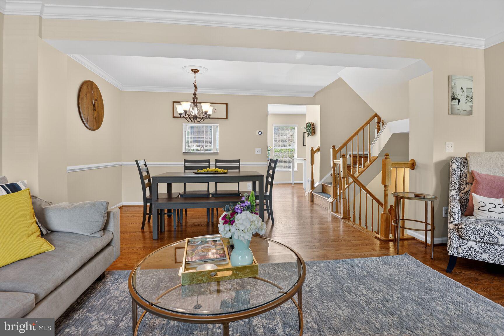 917 Rolfe Place Alexandria, VA 22314 - Photo 8 of 34 a living room with furniture a dining table and a chandelier