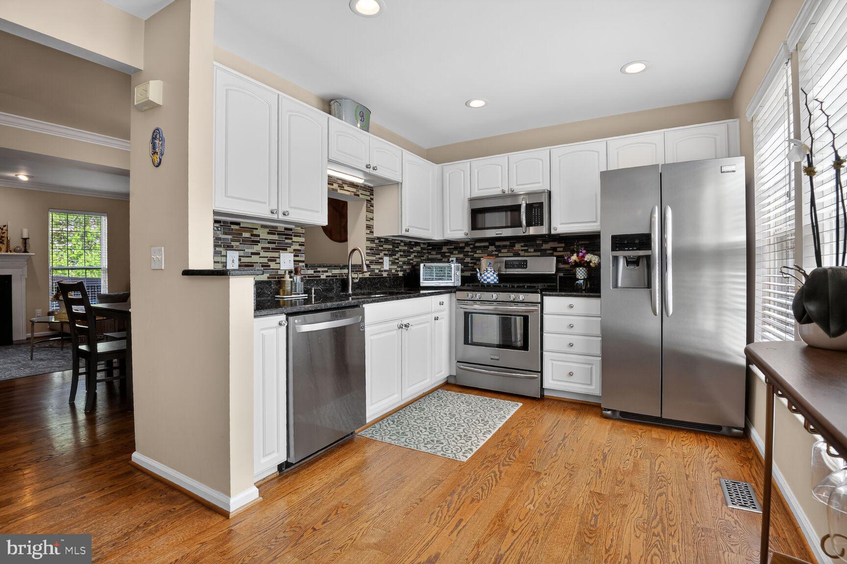 917 Rolfe Place Alexandria, VA 22314 - Photo 9 of 34 a kitchen with stainless steel appliances a refrigerator sink and cabinets