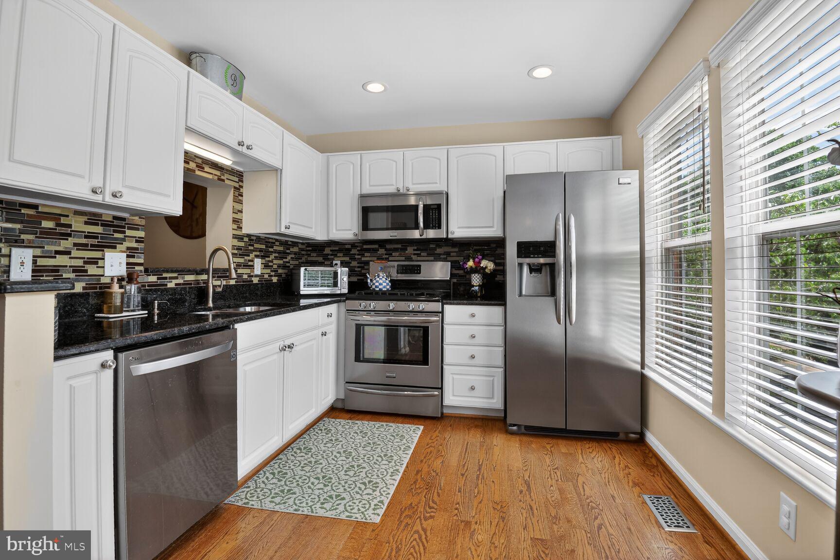 917 Rolfe Place Alexandria, VA 22314 - Photo 10 of 34 a kitchen with stainless steel appliances granite countertop a stove a sink and a refrigerator
