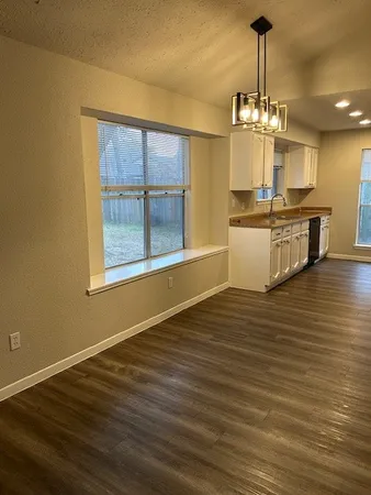 a bathroom with a granite countertop toilet sink and mirror