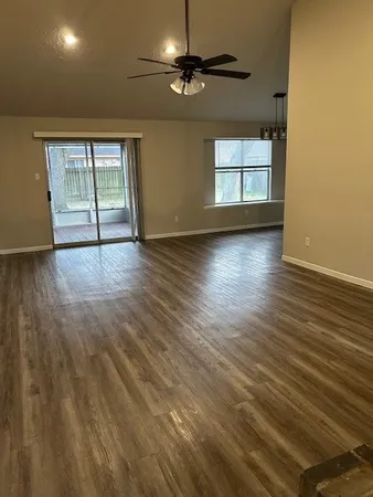 a view of a room with wooden floor and chandelier