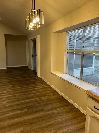 a view of a livingroom with wooden floor