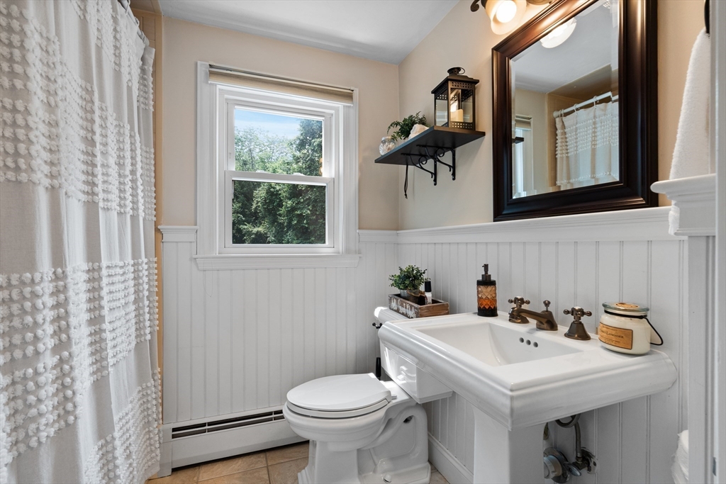 27 Pleasant Street Millis, MA 02054 - Photo 11 of 42 a bathroom with a sink a toilet and mirror
