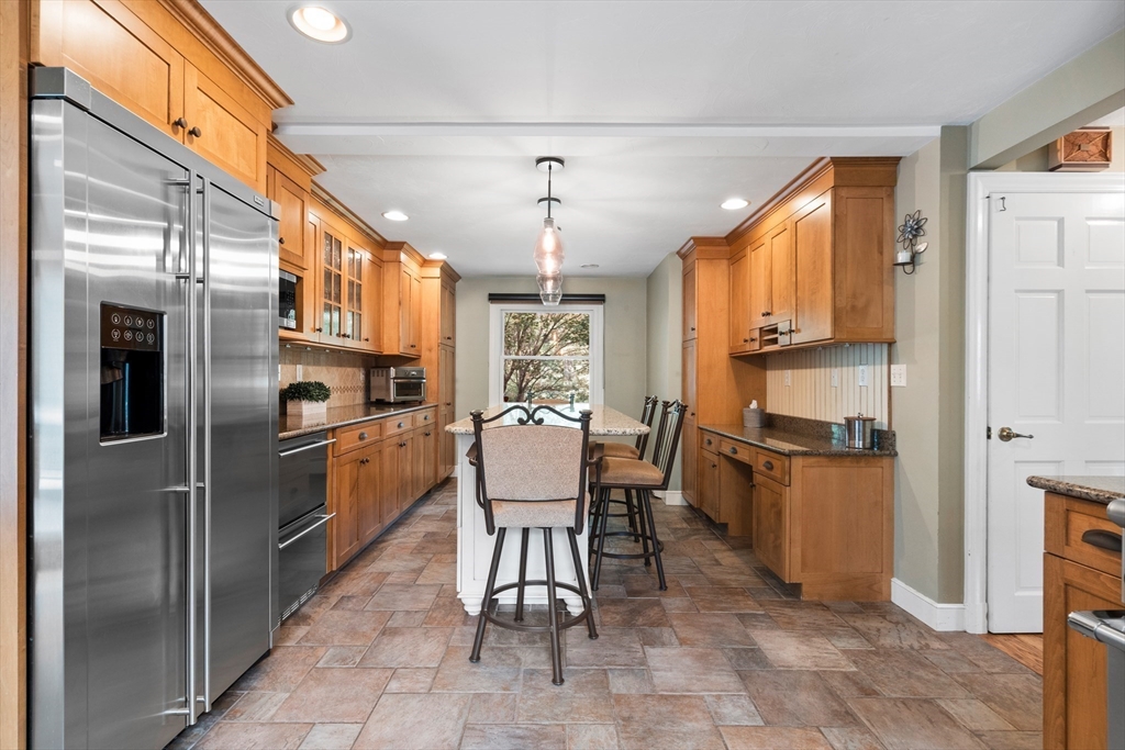 27 Pleasant Street Millis, MA 02054 - Photo 12 of 42 a kitchen with stainless steel appliances a refrigerator stove microwave and cabinets