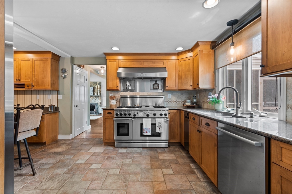 27 Pleasant Street Millis, MA 02054 - Photo 13 of 42 a kitchen with stainless steel appliances granite countertop a stove sink and cabinets