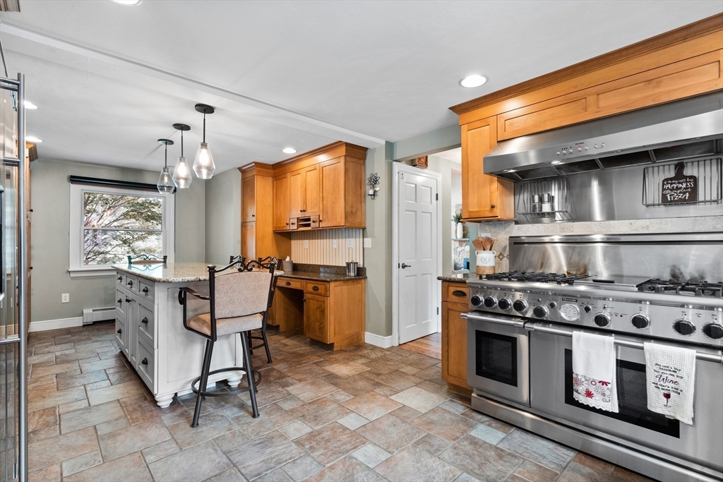 27 Pleasant Street Millis, MA 02054 - Photo 14 of 42 a kitchen with stainless steel appliances a stove a sink and cabinets