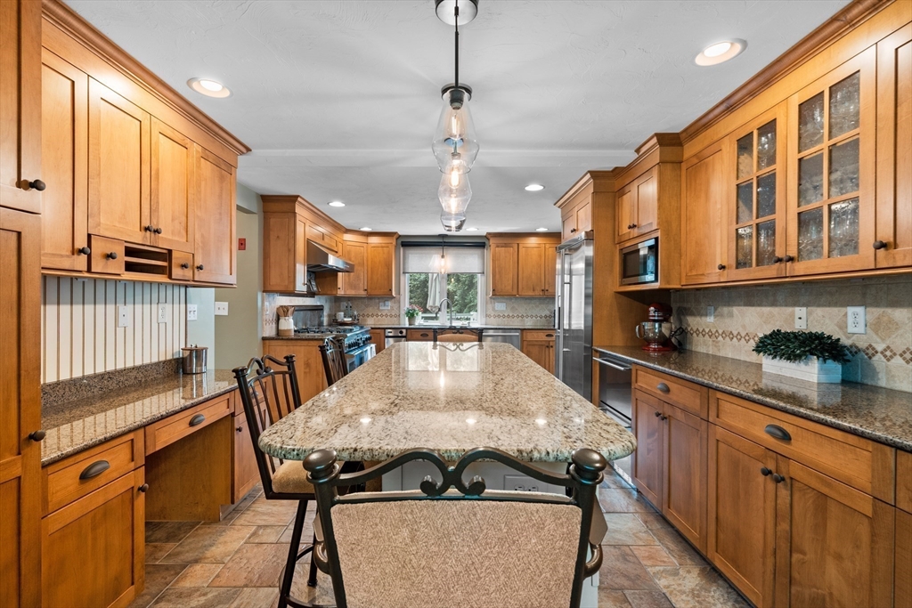 27 Pleasant Street Millis, MA 02054 - Photo 16 of 42 a kitchen with stainless steel appliances granite countertop a kitchen island a stove and a sink