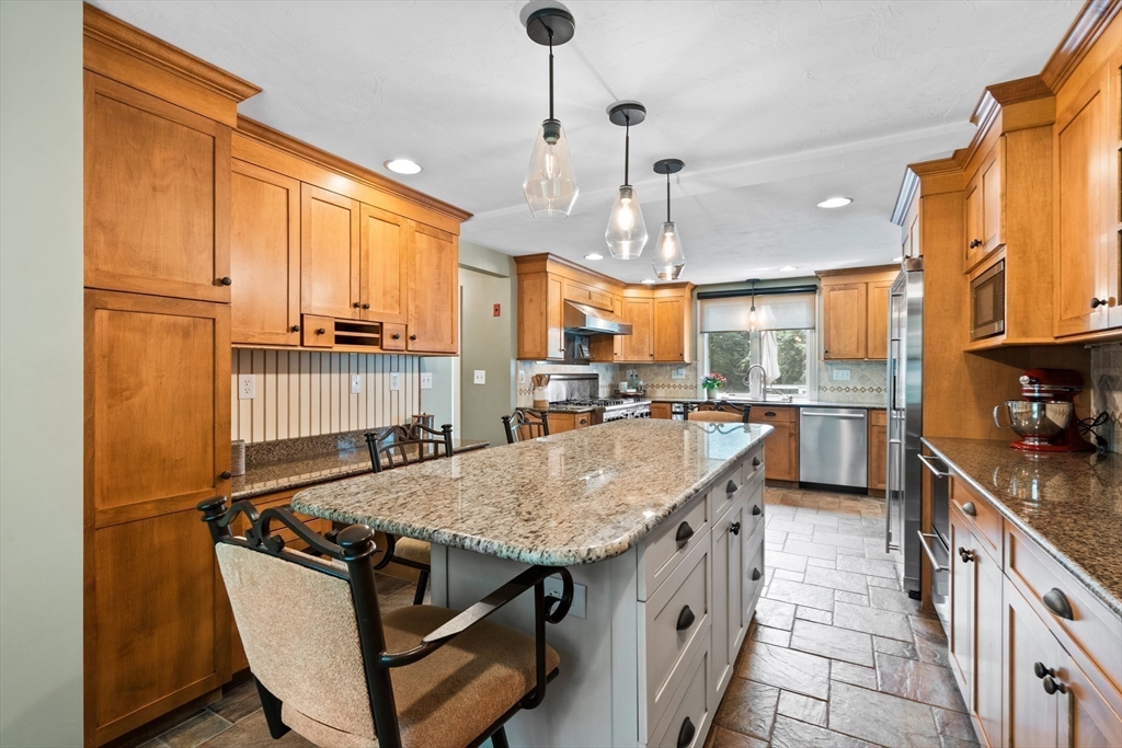 27 Pleasant Street Millis, MA 02054 - Photo 17 of 42 a kitchen with stainless steel appliances granite countertop a sink stove and refrigerator