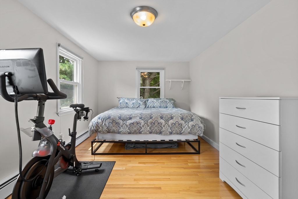 27 Pleasant Street Millis, MA 02054 - Photo 30 of 42 a bedroom with a bed and a flat tv screen on the dresser