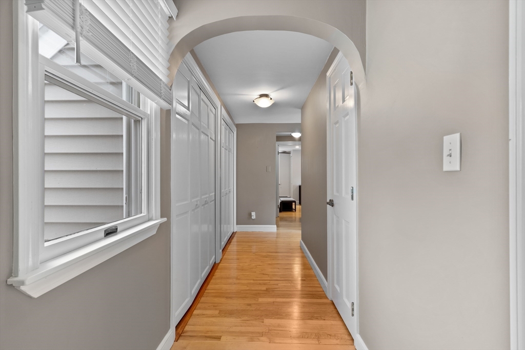 27 Pleasant Street Millis, MA 02054 - Photo 32 of 42 a view of a hallway with wooden floor and staircase