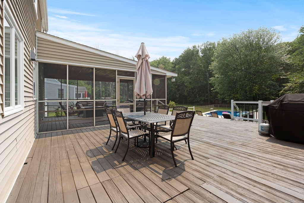27 Pleasant Street Millis, MA 02054 - Photo 37 of 42 a view of a roof deck with table and chairs and wooden floor