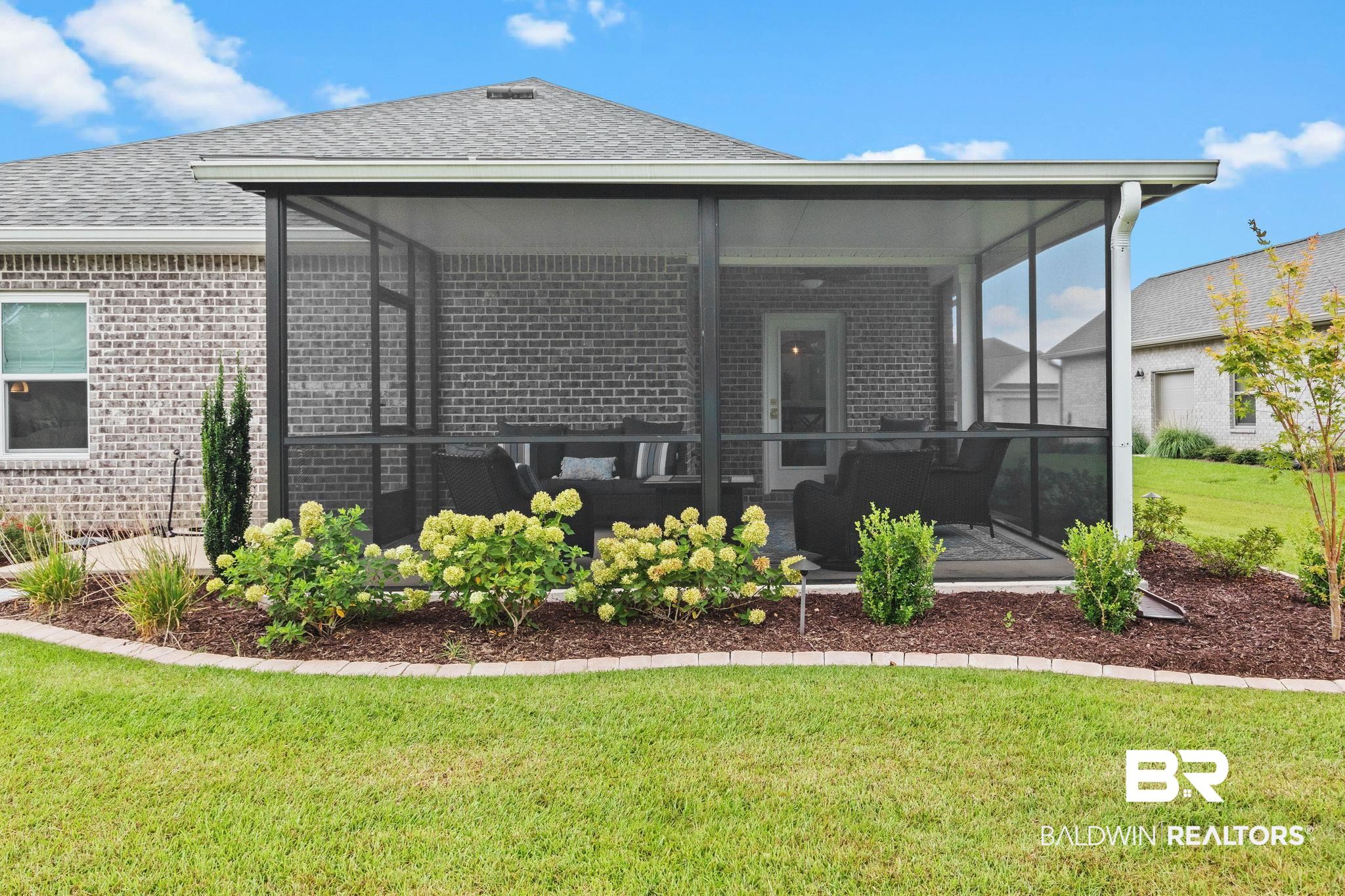 9815 Lakeview Drive Foley, AL 36535 - Photo 73 of 100 Rear view of house featuring a sunroom and a lawn