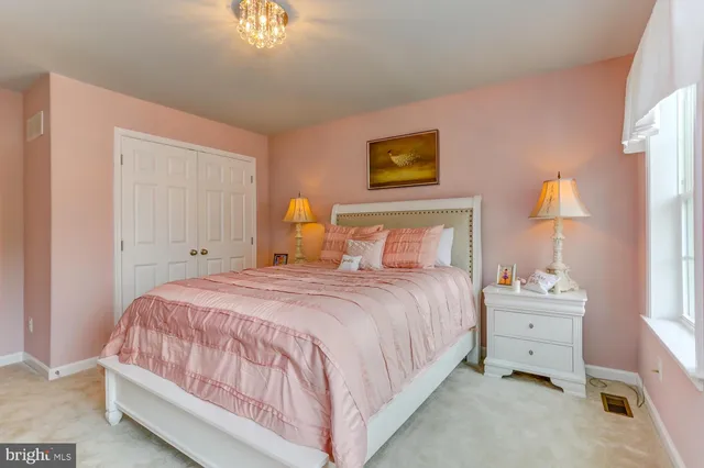 a bedroom with a bed and a lamp