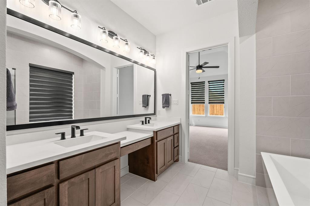 4805 Impression Lane Prosper, TX 75078 - Photo 17 of 34 a bathroom with a sink double vanity and a mirror