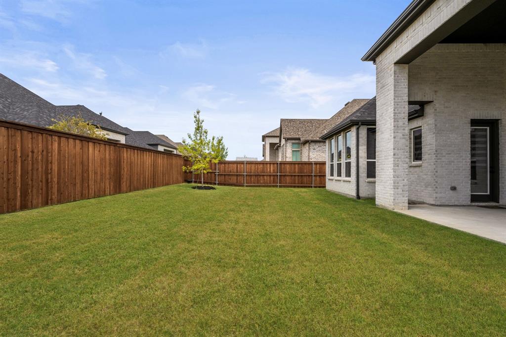 4805 Impression Lane Prosper, TX 75078 - Photo 24 of 34 a view of a house with backyard and garden
