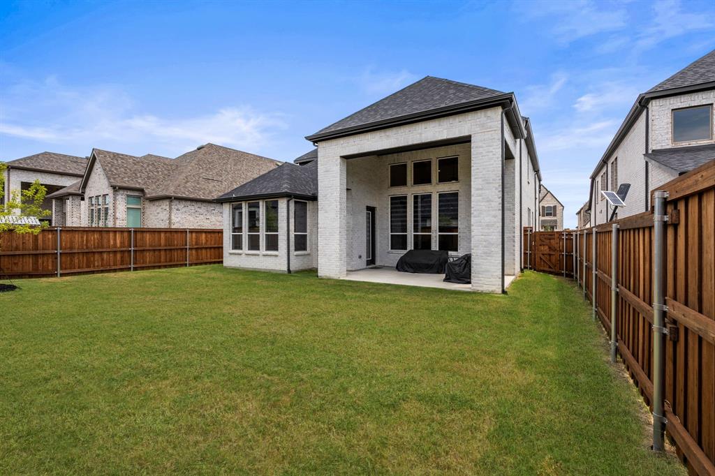 4805 Impression Lane Prosper, TX 75078 - Photo 25 of 34 a view of a house with backyard and porch