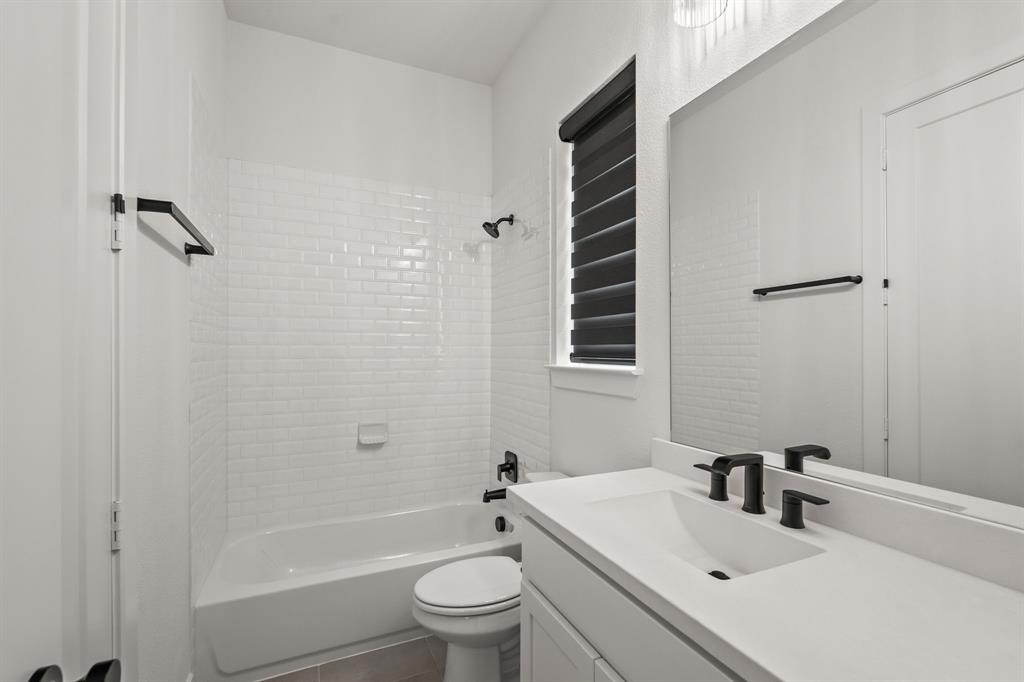 4805 Impression Lane Prosper, TX 75078 - Photo 6 of 34 a bathroom with a sink toilet and shower