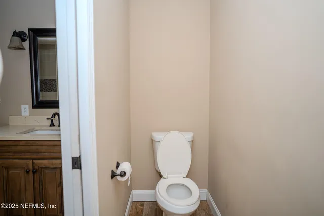 a white toilet sitting next to a bathroom sink