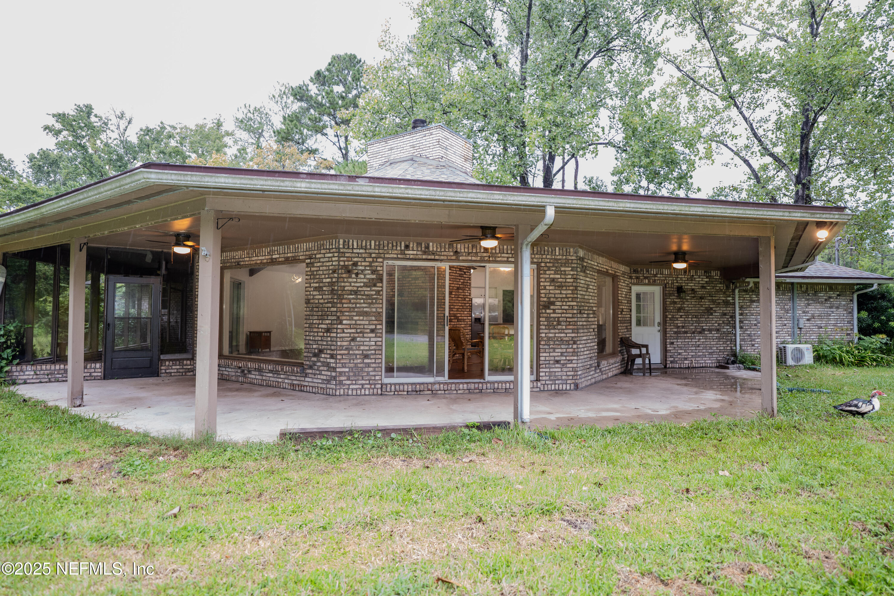 3098 Pacetti Road, Unit I St. Augustine, FL 32092 - Photo 22 of 29 a view of a patio with table and chairs and potted plants with large tree