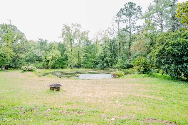 a view of a swimming pool with an outdoor space and seating area