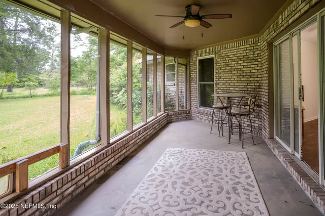 a view of a porch with chairs and backyard