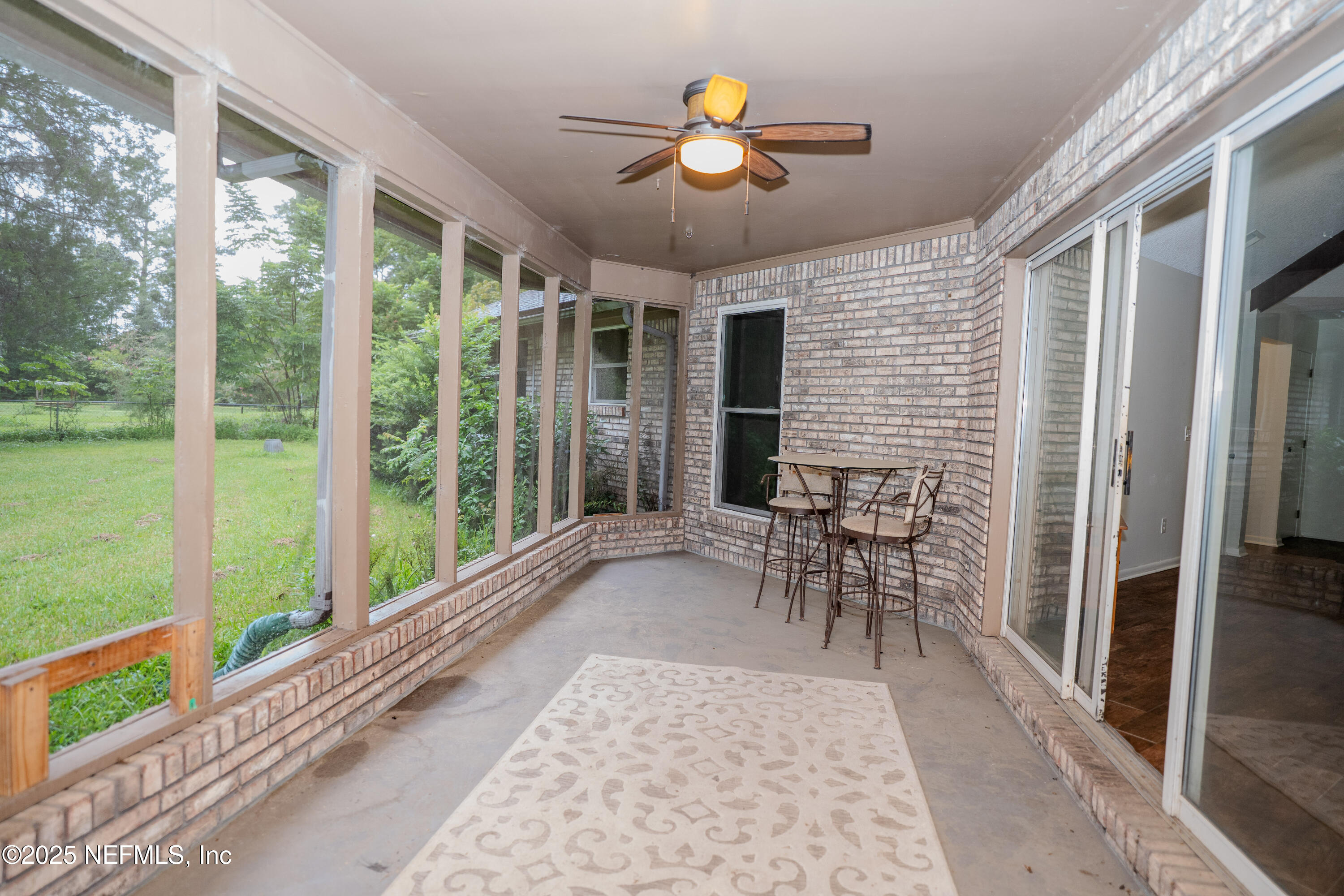 3098 Pacetti Road, Unit I St. Augustine, FL 32092 - Photo 27 of 29 a view of a porch with chairs and backyard