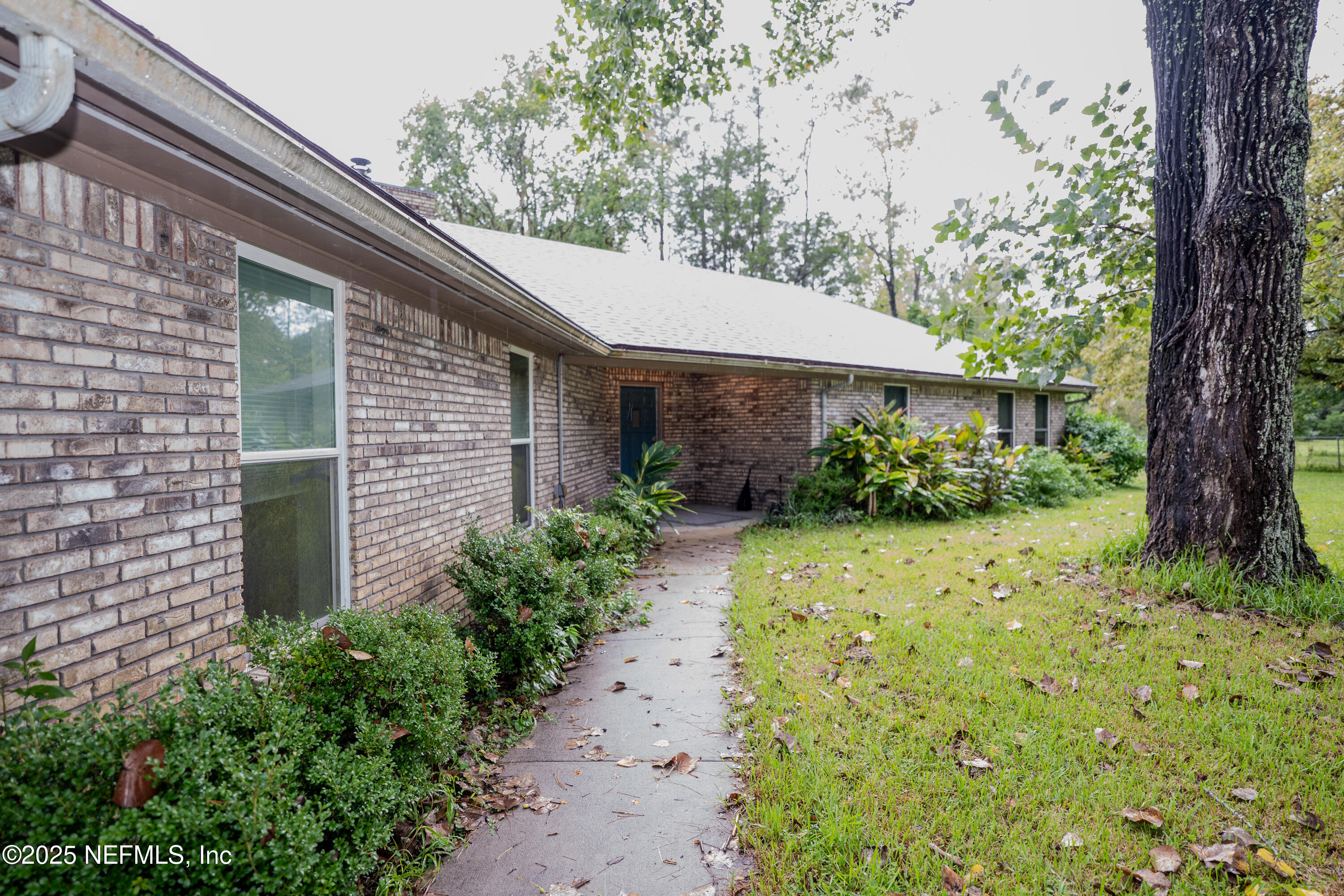3098 Pacetti Road, Unit I St. Augustine, FL 32092 - Photo 28 of 29 a couple of flower plants in front of house