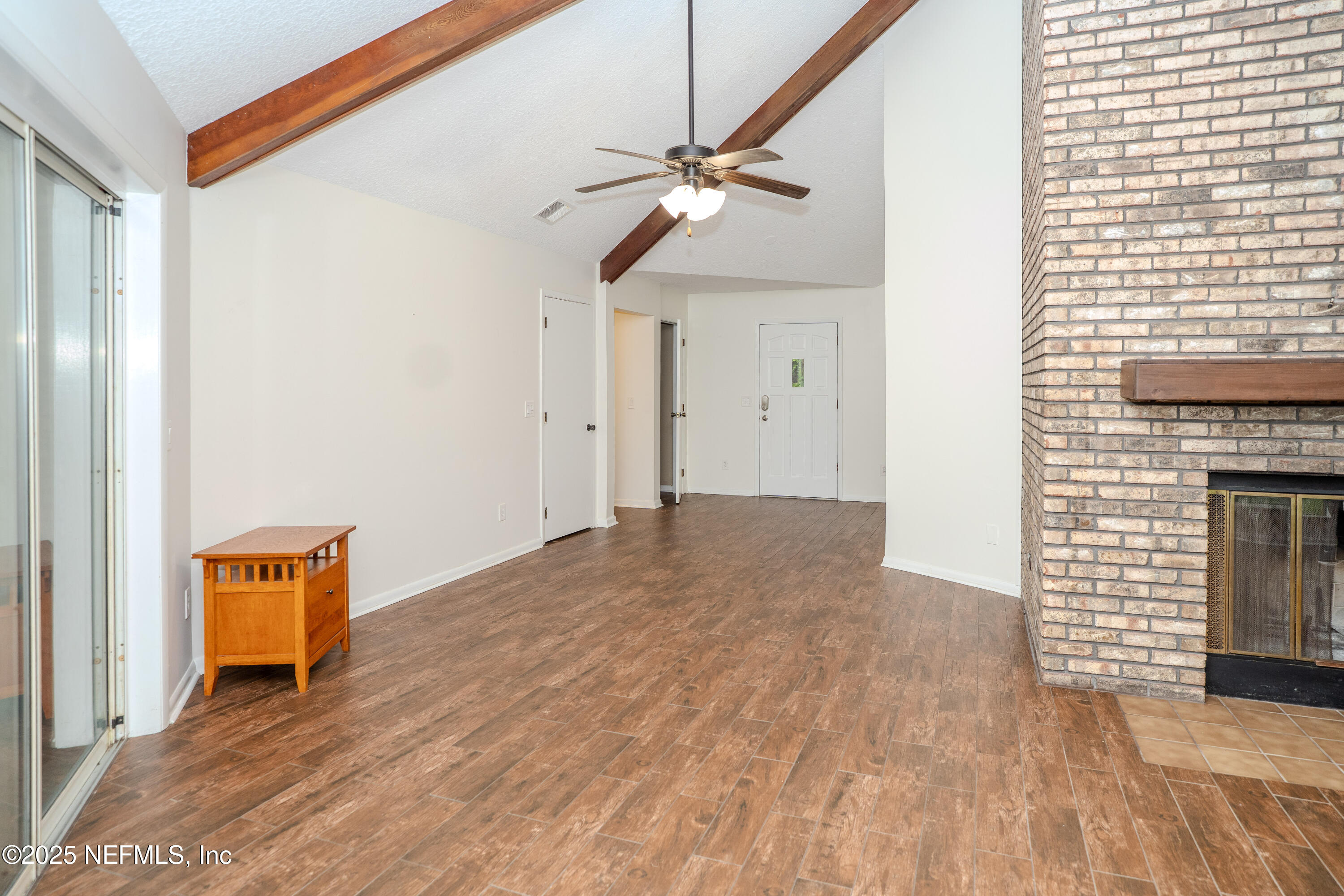 3098 Pacetti Road, Unit I St. Augustine, FL 32092 - Photo 3 of 29 a view of empty room with wooden floor and fan
