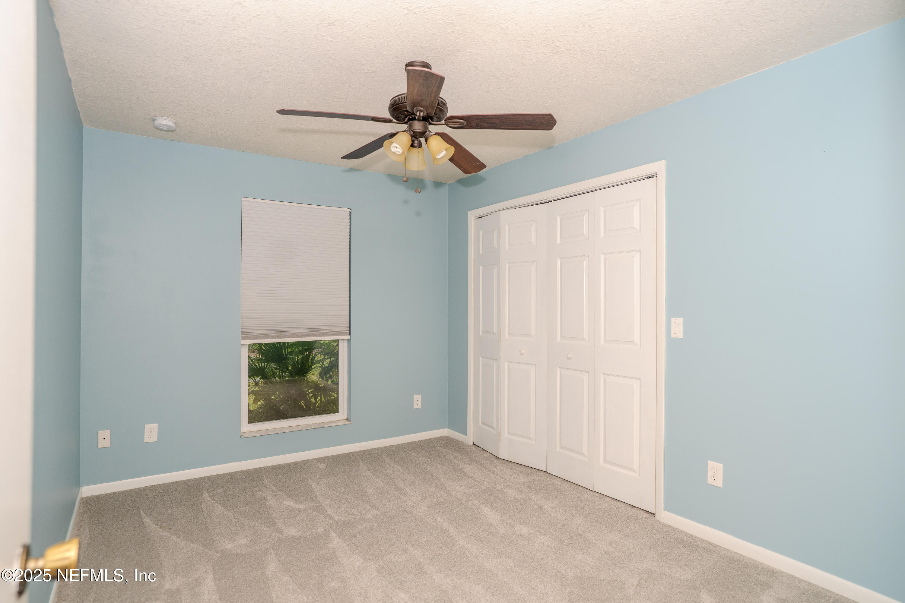 3098 Pacetti Road, Unit I St. Augustine, FL 32092 - Photo 7 of 29 an empty room with windows and fan
