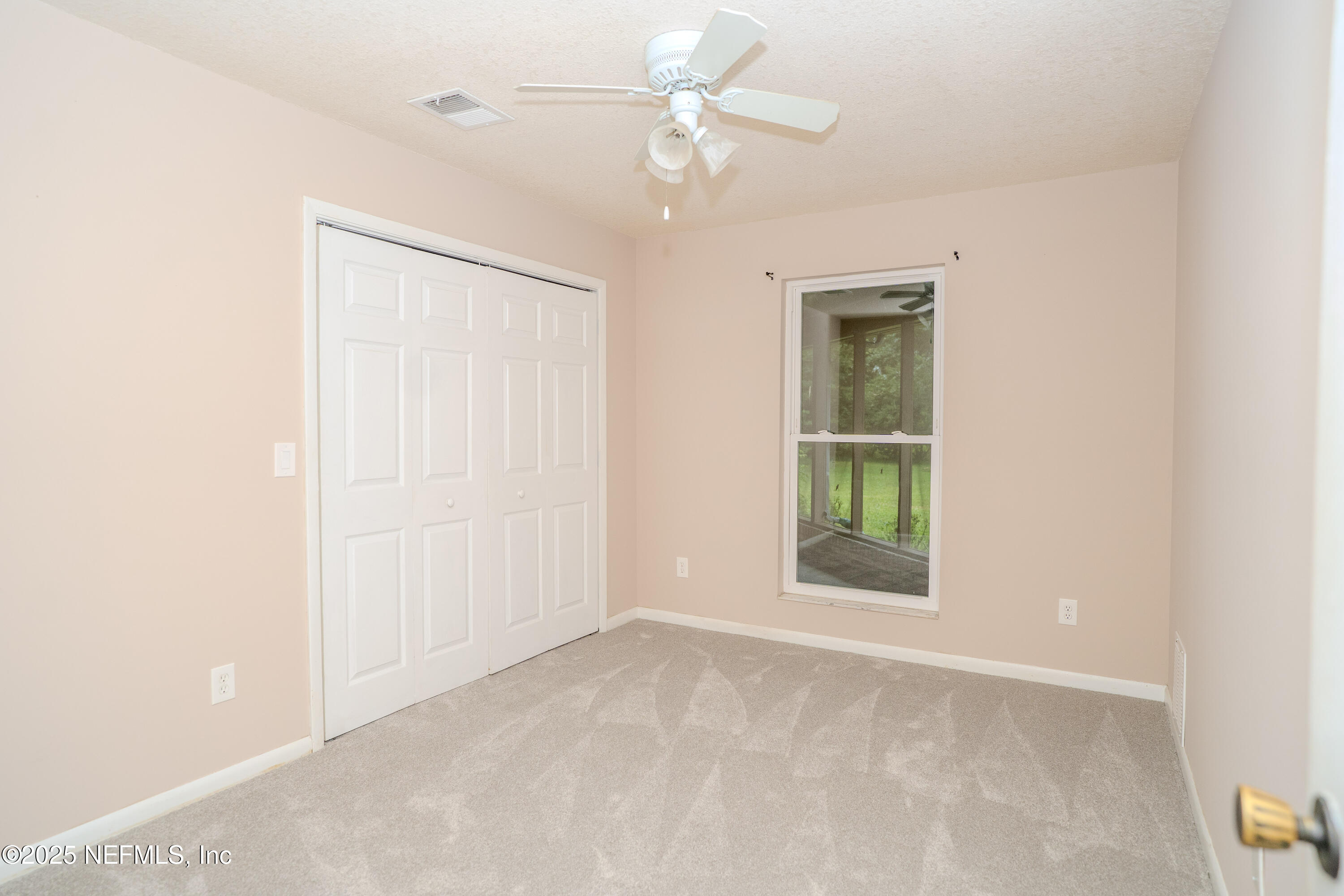 3098 Pacetti Road, Unit I St. Augustine, FL 32092 - Photo 8 of 29 an empty room with fan and windows