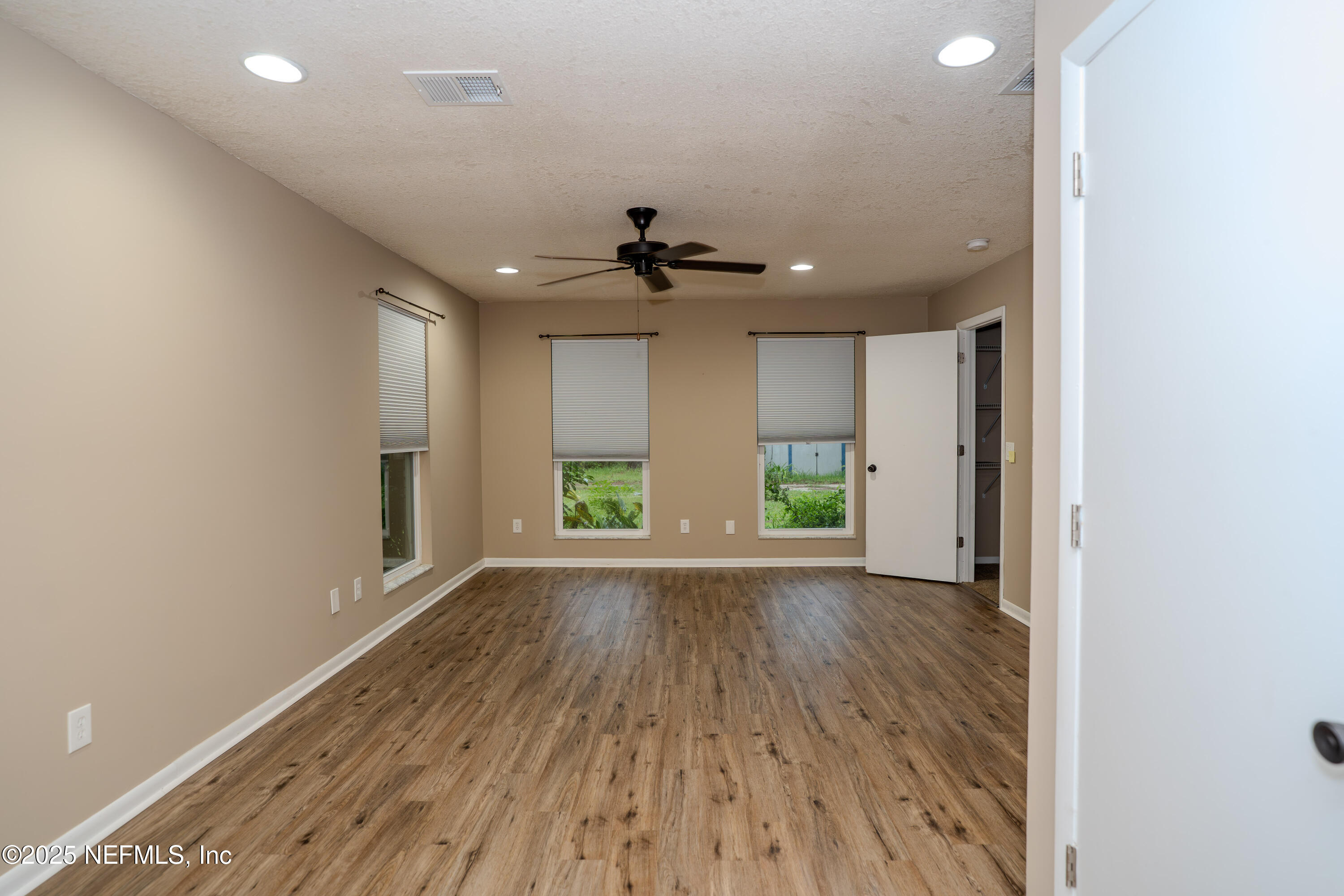 3098 Pacetti Road, Unit I St. Augustine, FL 32092 - Photo 10 of 29 wooden floor in an empty room with a window