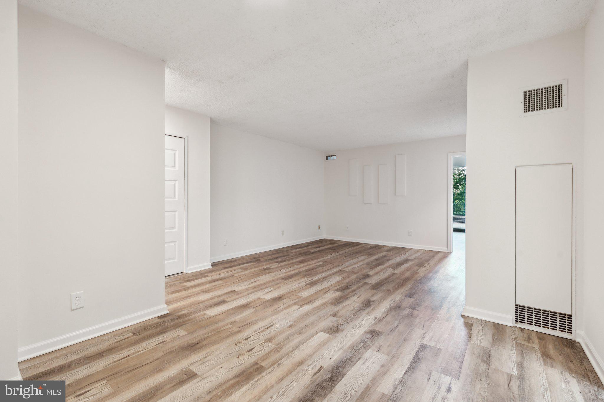 1800 Old Meadow Road, Unit 115 McLean, VA 22102 - Photo 11 of 35 a view of empty room with wooden floor