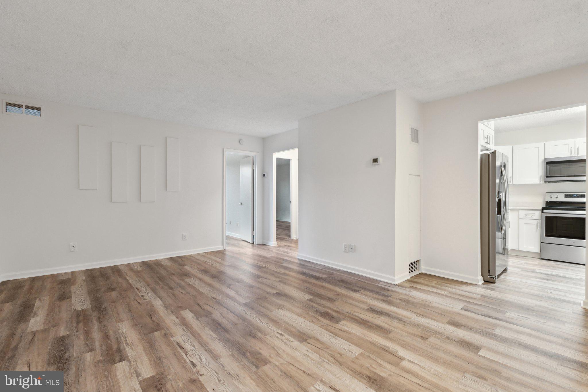 1800 Old Meadow Road, Unit 115 McLean, VA 22102 - Photo 12 of 35 a view of empty room with wooden floor