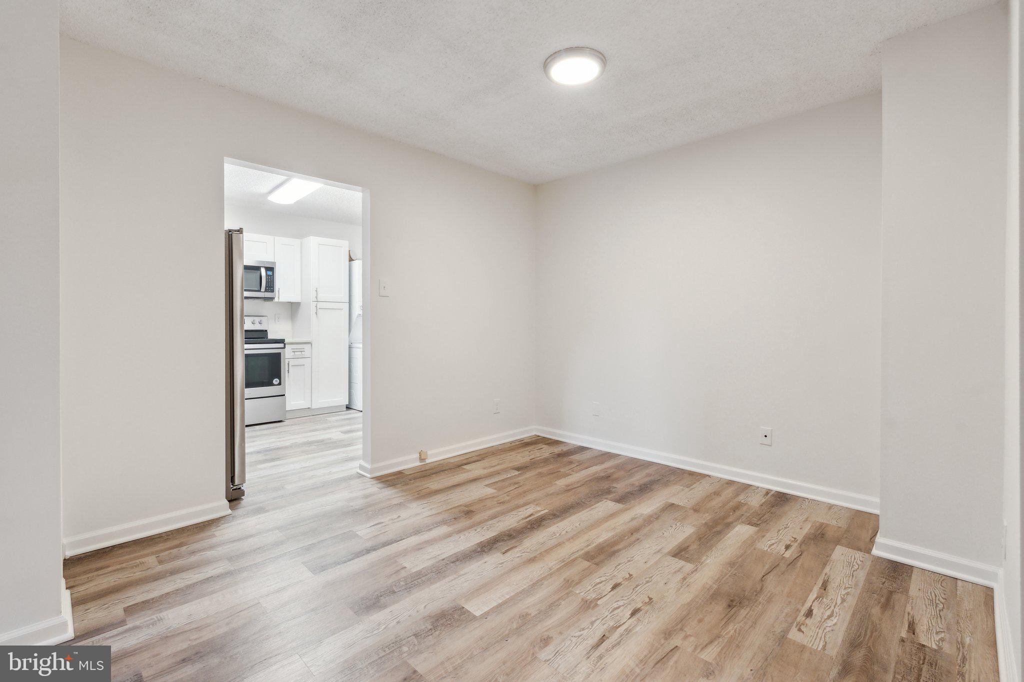 1800 Old Meadow Road, Unit 115 McLean, VA 22102 - Photo 13 of 35 wooden floor in an empty room