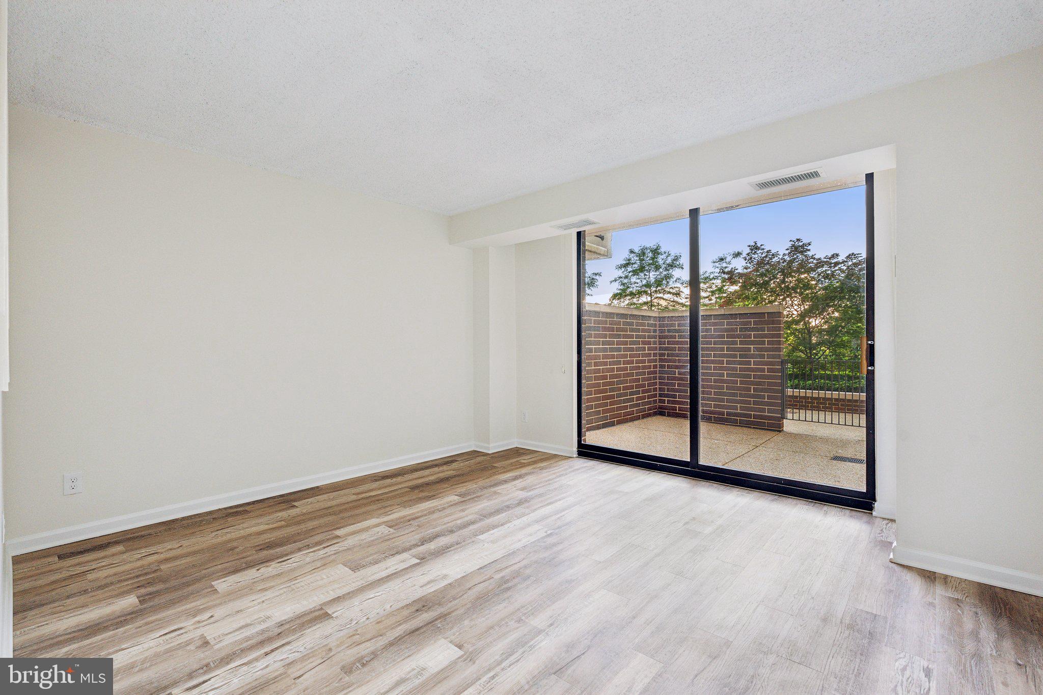 1800 Old Meadow Road, Unit 115 McLean, VA 22102 - Photo 19 of 35 a view of a room with wooden floor and window