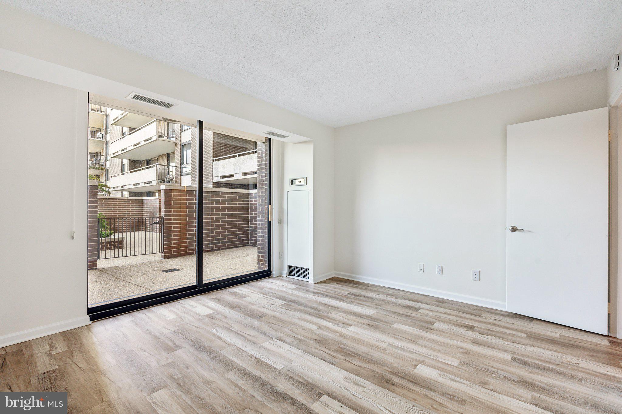 1800 Old Meadow Road, Unit 115 McLean, VA 22102 - Photo 20 of 35 a view of an empty room with glass door