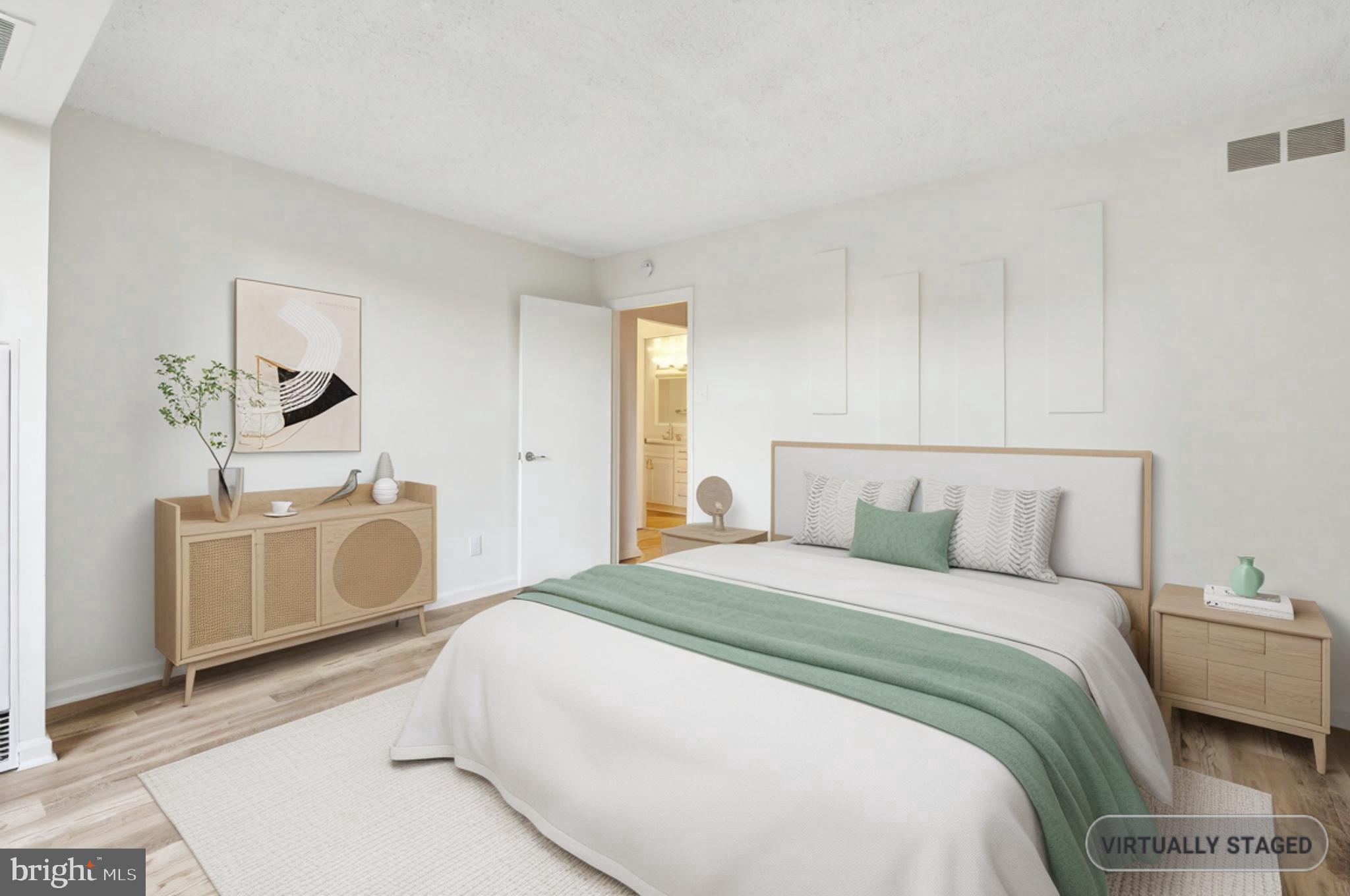 1800 Old Meadow Road, Unit 115 McLean, VA 22102 - Photo 22 of 35 a bedroom with a white bed and a dresser