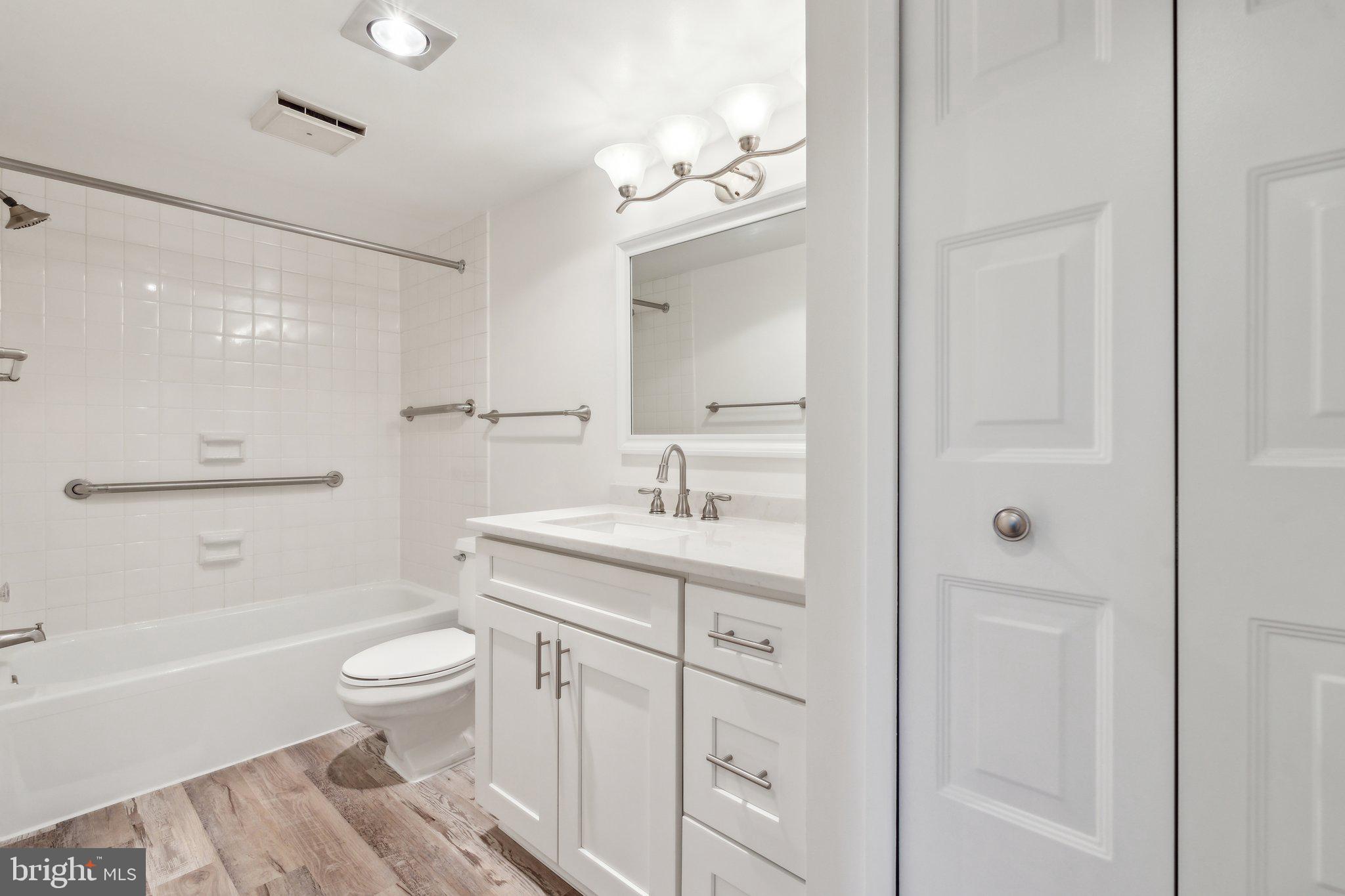 1800 Old Meadow Road, Unit 115 McLean, VA 22102 - Photo 23 of 35 a bathroom with a sink a toilet and bathtub