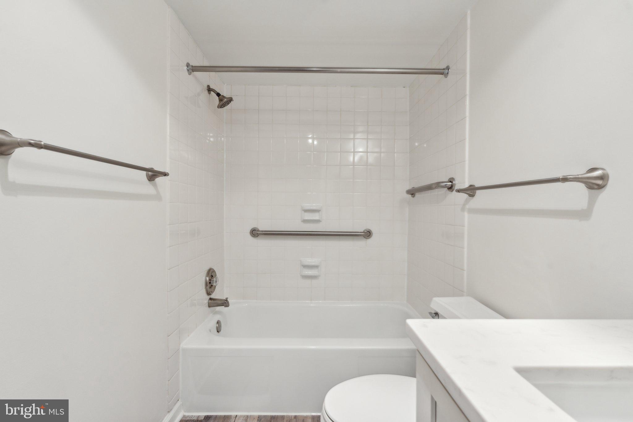 1800 Old Meadow Road, Unit 115 McLean, VA 22102 - Photo 24 of 35 a bathroom with a sink a toilet and a bathtub
