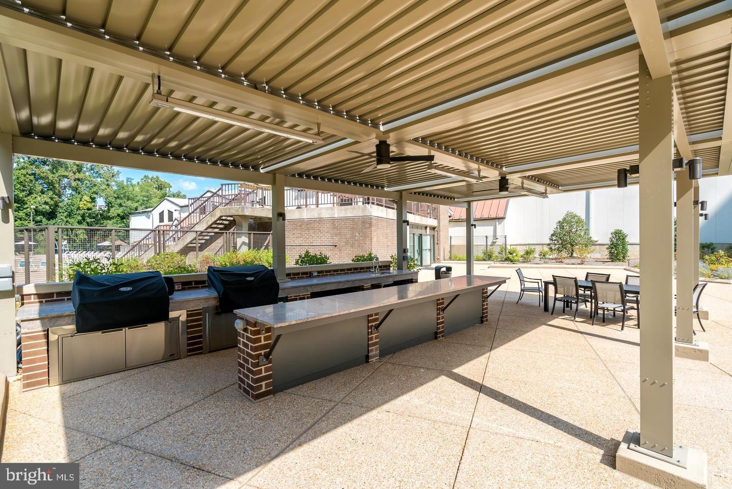1800 Old Meadow Road, Unit 115 McLean, VA 22102 - Photo 35 of 35 a view of a patio with a table and chairs
