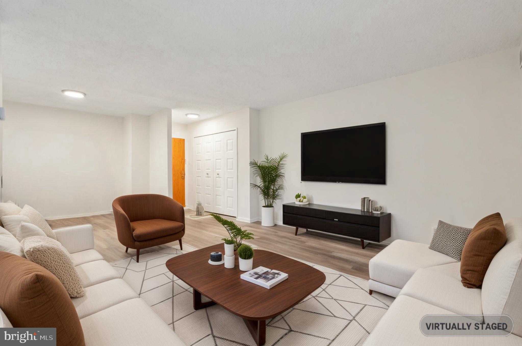 1800 Old Meadow Road, Unit 115 McLean, VA 22102 - Photo 10 of 35 a living room with furniture and a flat screen tv
