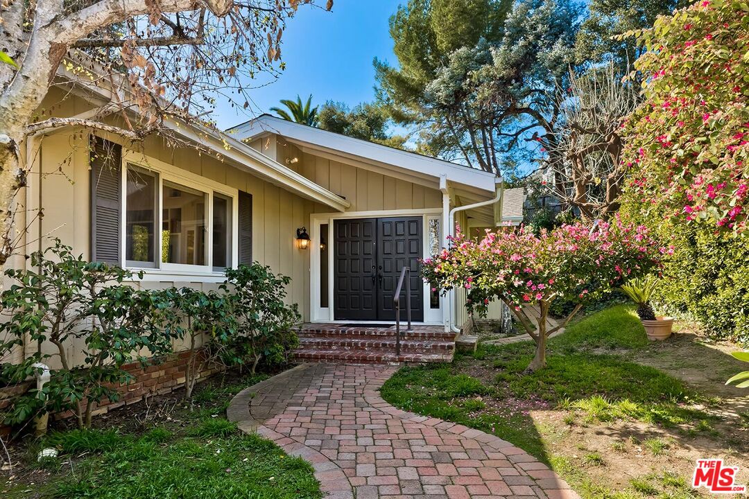 751 Teakwood Road Los Angeles, CA 90049 - Photo 1 of 46 a front view of house with a garden