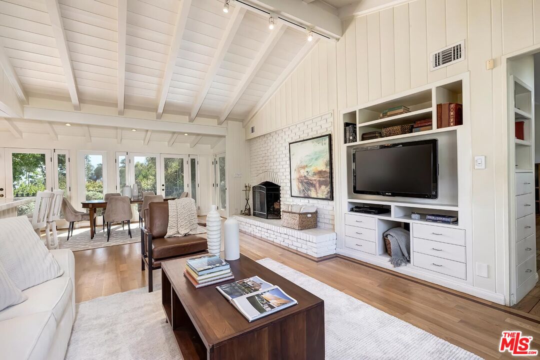 751 Teakwood Road Los Angeles, CA 90049 - Photo 13 of 46 a living room with furniture and a flat screen tv