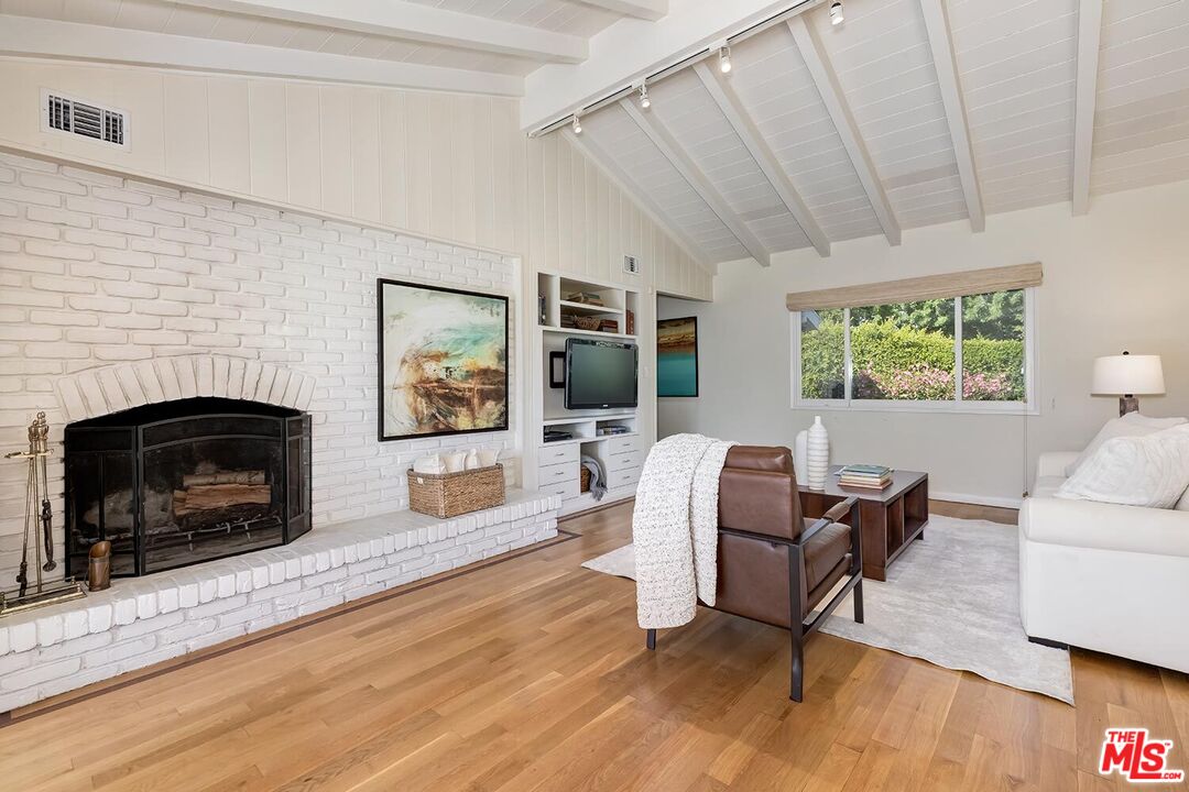 751 Teakwood Road Los Angeles, CA 90049 - Photo 15 of 46 a living room with furniture and a fireplace
