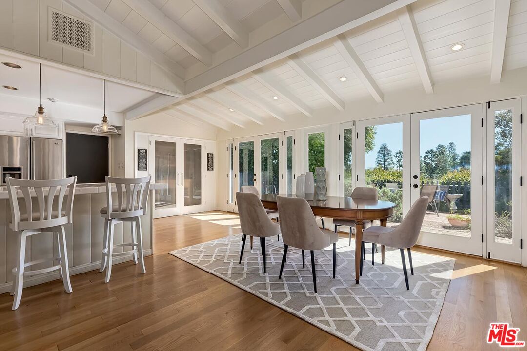 751 Teakwood Road Los Angeles, CA 90049 - Photo 16 of 46 a view of a dining room with furniture and wooden floor