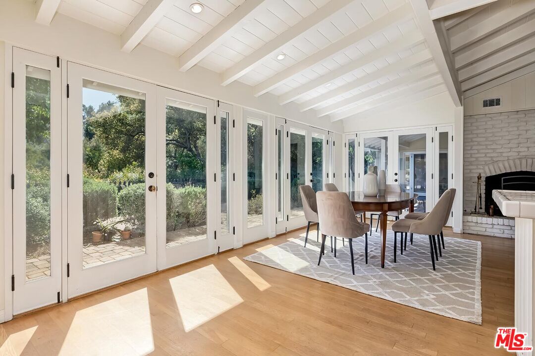 751 Teakwood Road Los Angeles, CA 90049 - Photo 18 of 46 a dining room with furniture a chandelier and wooden floor