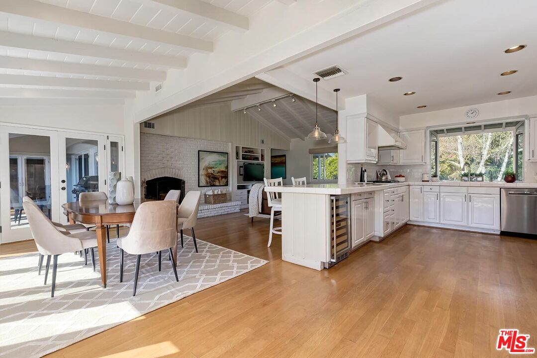 751 Teakwood Road Los Angeles, CA 90049 - Photo 19 of 46 a living room with kitchen island furniture and a wooden floor
