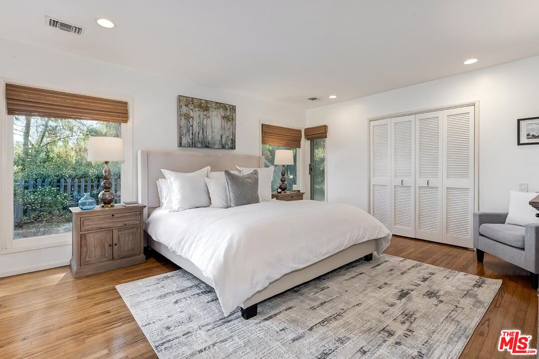 751 Teakwood Road Los Angeles, CA 90049 - Photo 24 of 46 a bedroom with a large bed and a couch