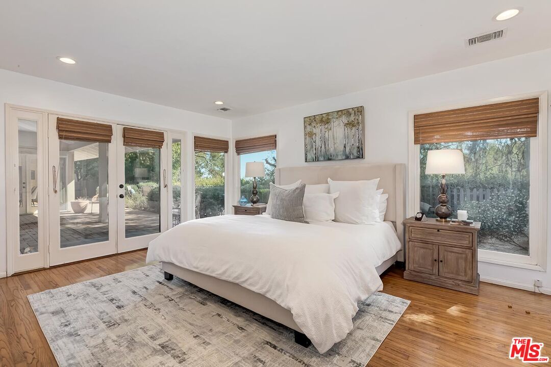 751 Teakwood Road Los Angeles, CA 90049 - Photo 25 of 46 a bedroom with a large bed and a large window